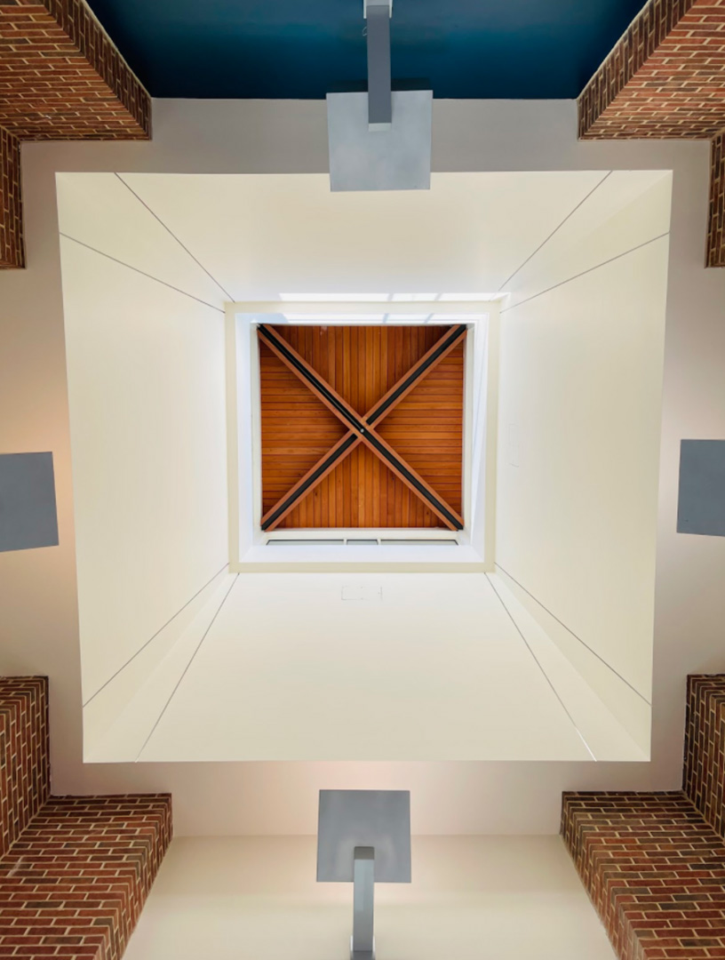 Artistic student architectural photo of a lofted ceiling that highlights geometric shapes and inset squares in the design.